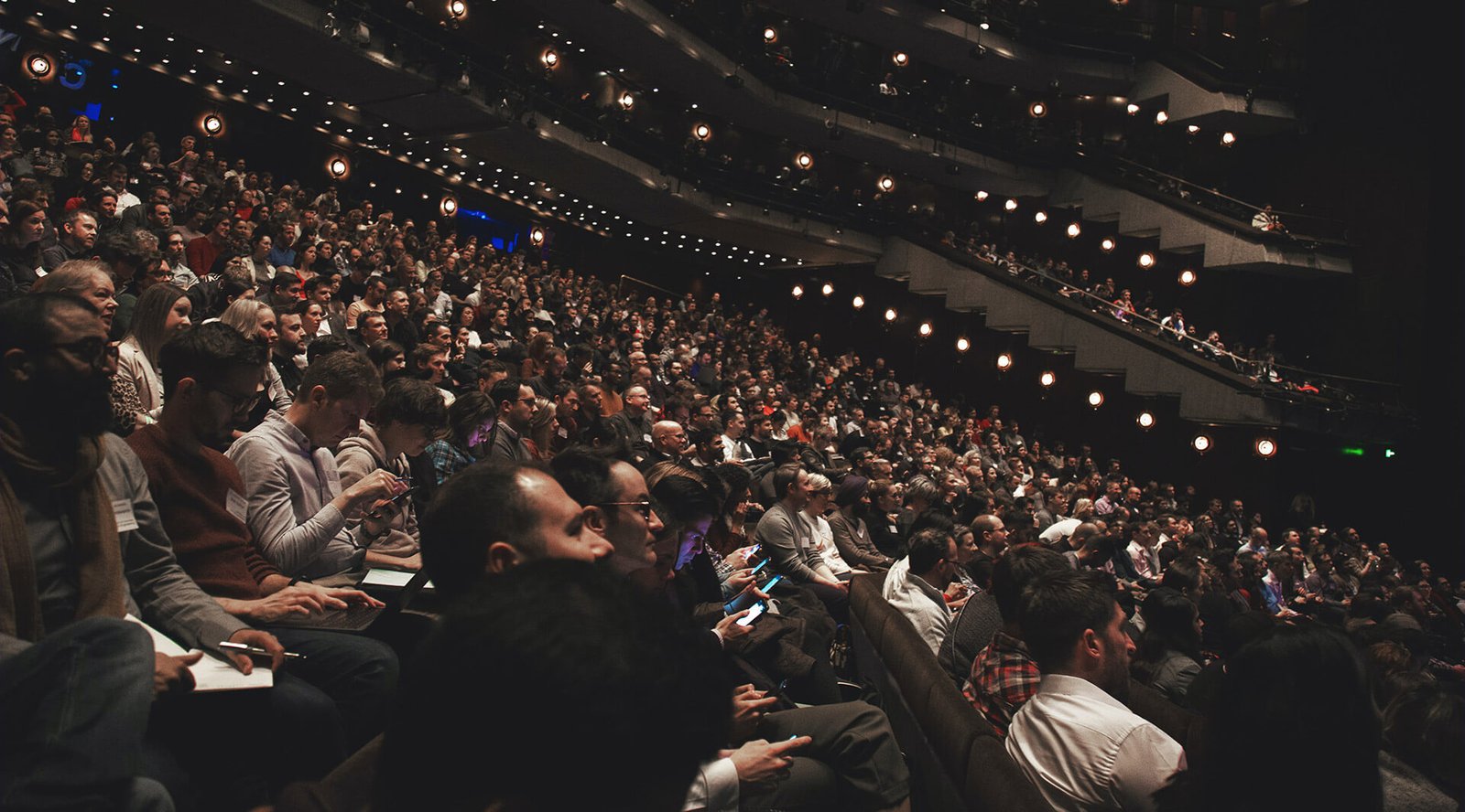A fully seated auditorium during a live event